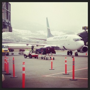 A WestJet flight from Toronto is parked outside the terminal in Kelowna.